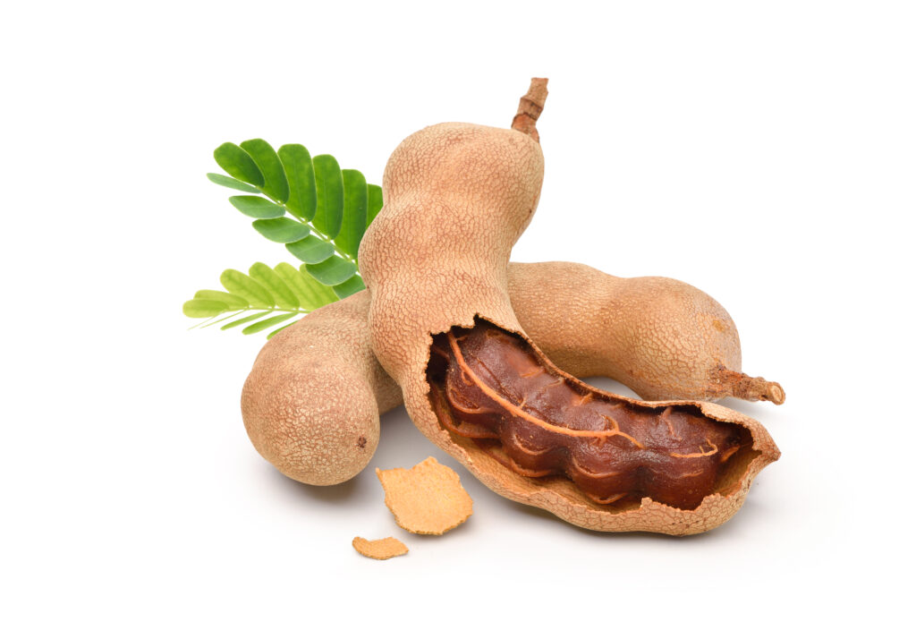 Tamarind,Fruits,With,Green,Leaves,Isolated,On,White,Background.